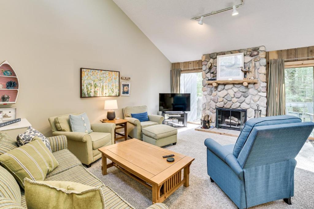 a living room with couches and a fireplace at Only 8/22-8/29 Still Available for Summer 2026! in Harbor Springs