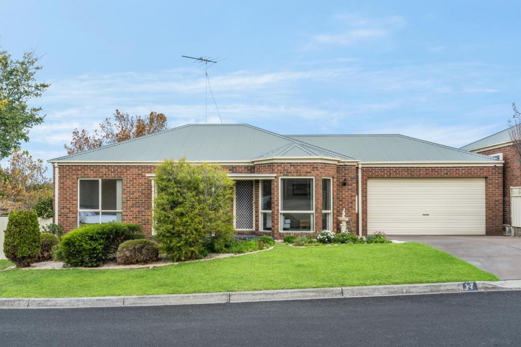 a brick house with a garage at Leopold holiday home in Leopold