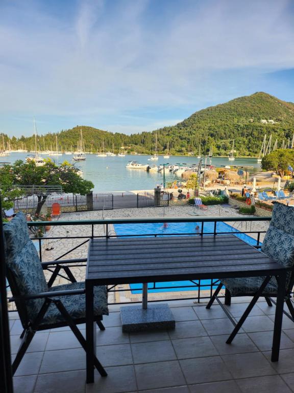 a table and chairs on a patio with a view of a harbor at MSK Studios in Nydri