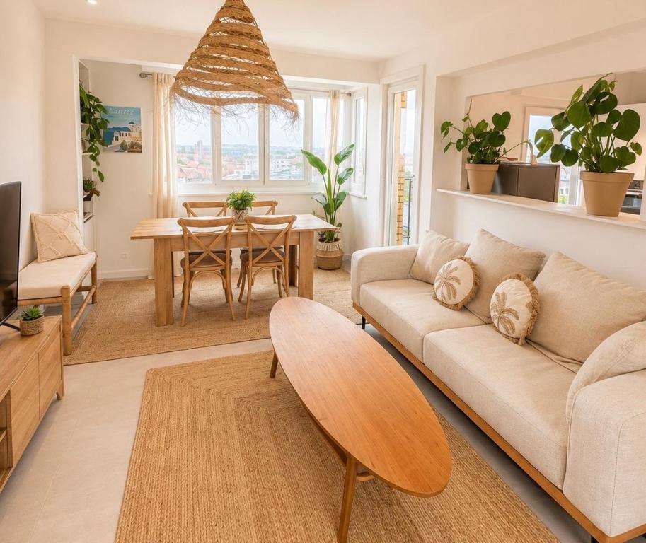 a living room with a couch and a table at Downtown Terrace with panoramic view in Tourcoing