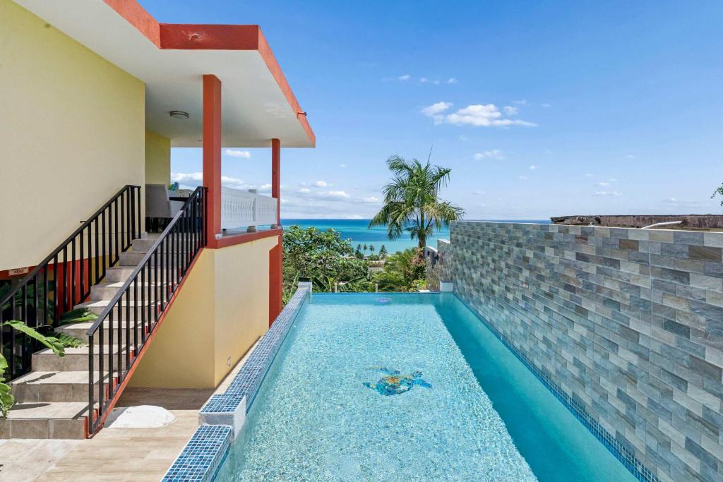 a swimming pool in a villa with a view of the ocean at Villa Marbella - Ocean Views & Private Pool in Luquillo