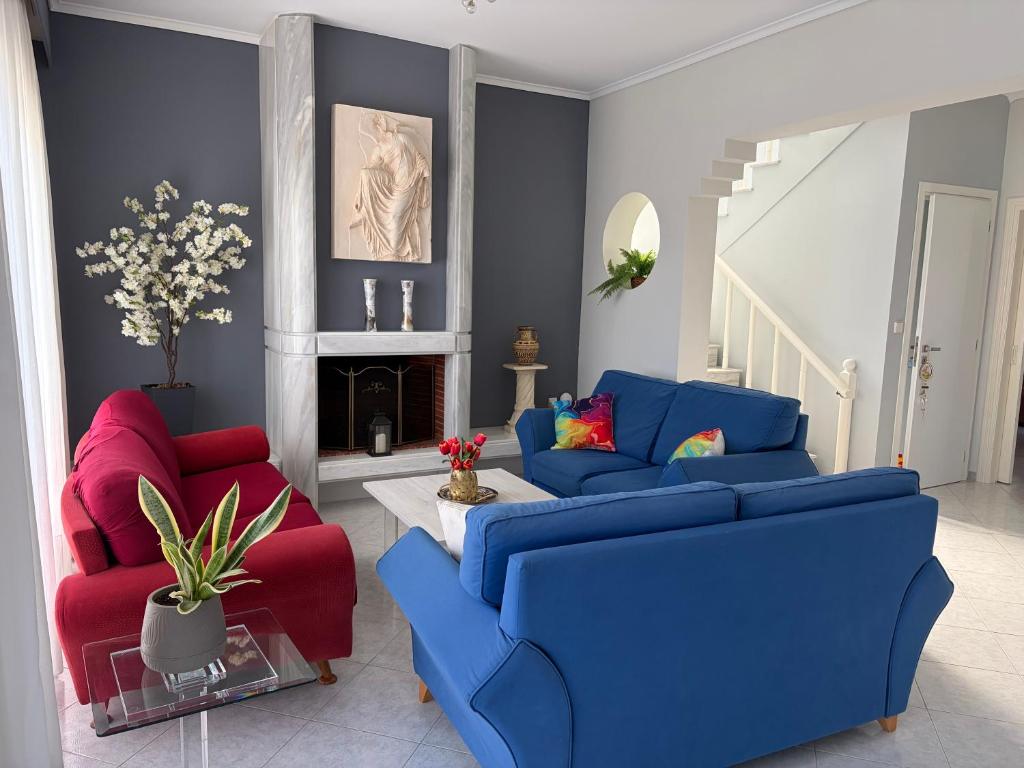 a living room with two blue and red couches at GianAngelo Holiday Villa in Kremasti
