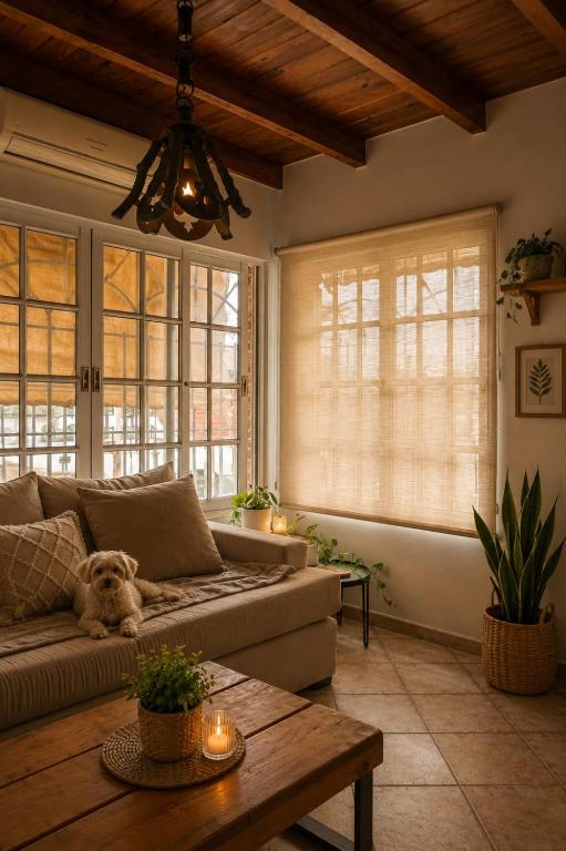 a living room with a couch and a table at Caelum House Familiar Con Cochera in Rafaela