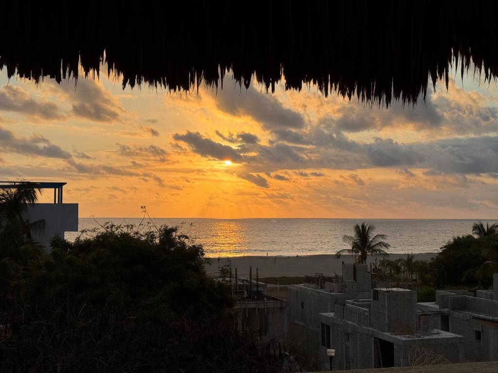 a sunset on the beach with the ocean at Casa Guadalupe - big beach oasis! in Brisas de Zicatela