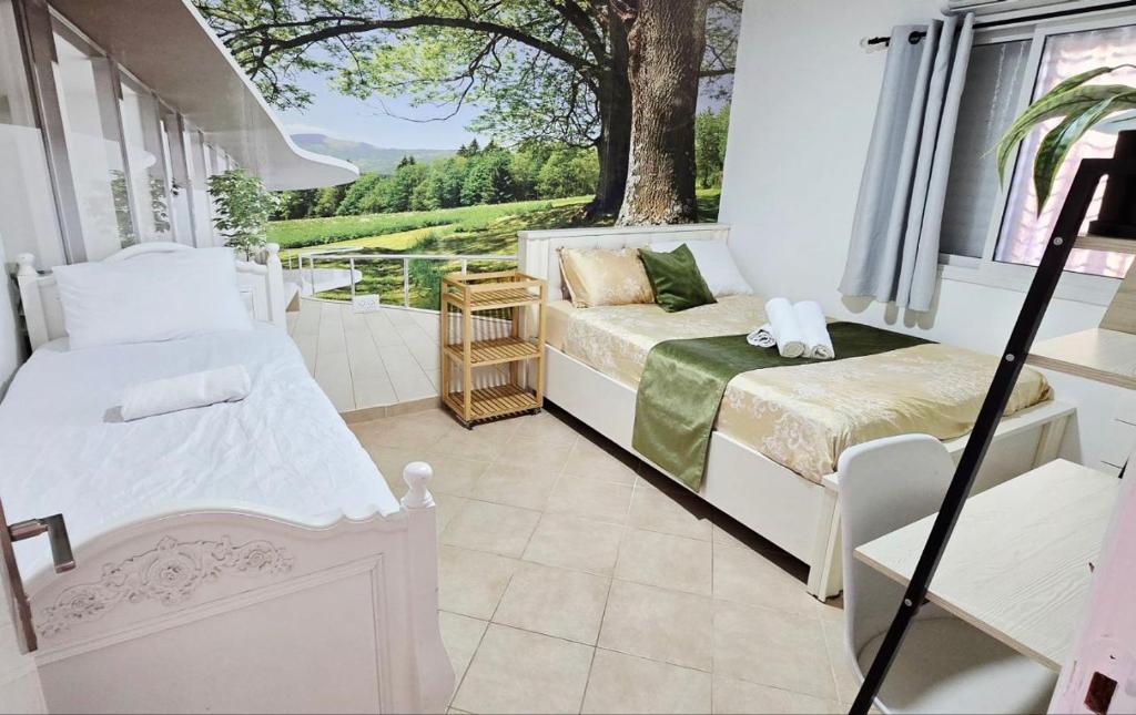 a bedroom with a bed and a window and a couch at BLAGO home Los Angeles 3 in Eilat