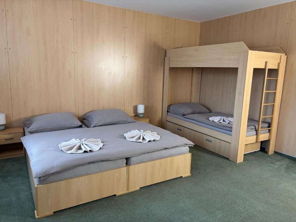 a bedroom with two bunk beds with towels on them at Ubytování Jívka 86 in Jívka