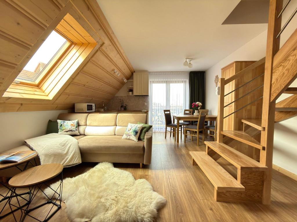 a living room with a couch and a table at Apartamenty 242E in Chochołów