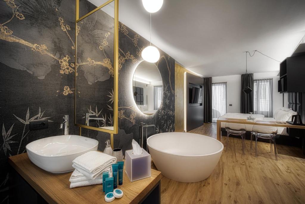 a bathroom with a large tub and a sink at M Loft - adults only in Malcesine