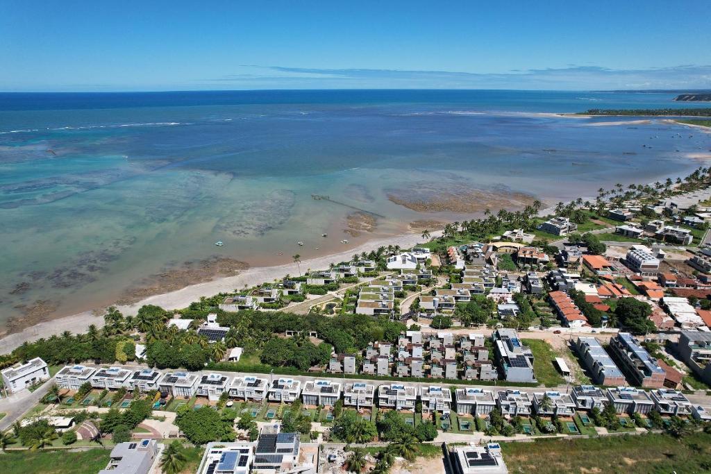 an aerial view of a beach with condos at Oka Milagres Beachfront Condominium By MME in Barra do Camaragibe