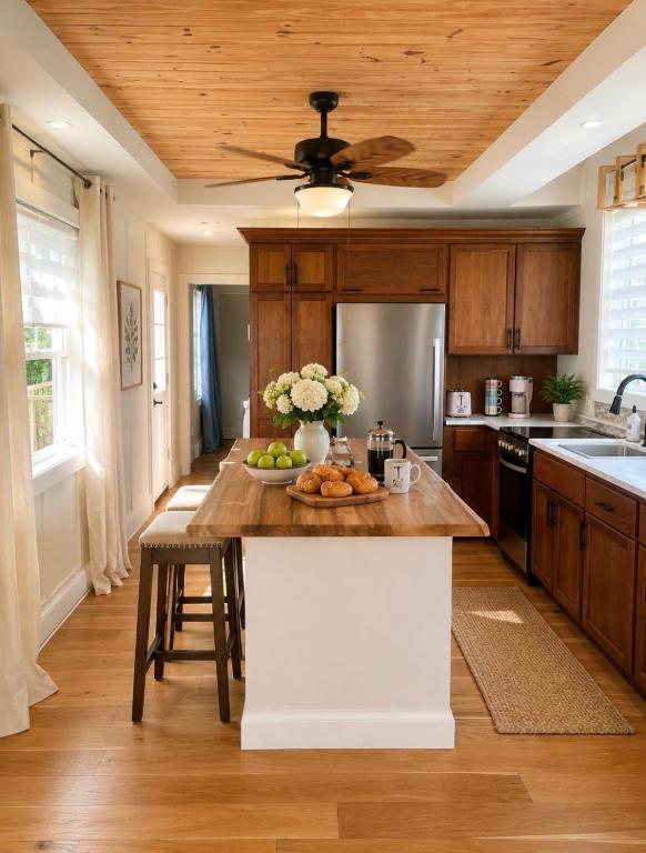 a kitchen with a table with a bowl of fruit on it at Honey & Hook Tiny Home with Breakfast in St. Catharines