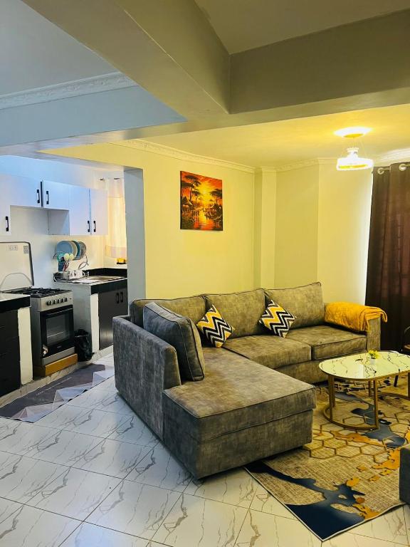 a living room with a couch and a table at T-Homes in Thika