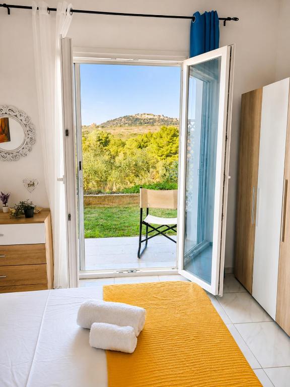 a bedroom with a bed and a sliding glass door at 4T apartments in Argostoli
