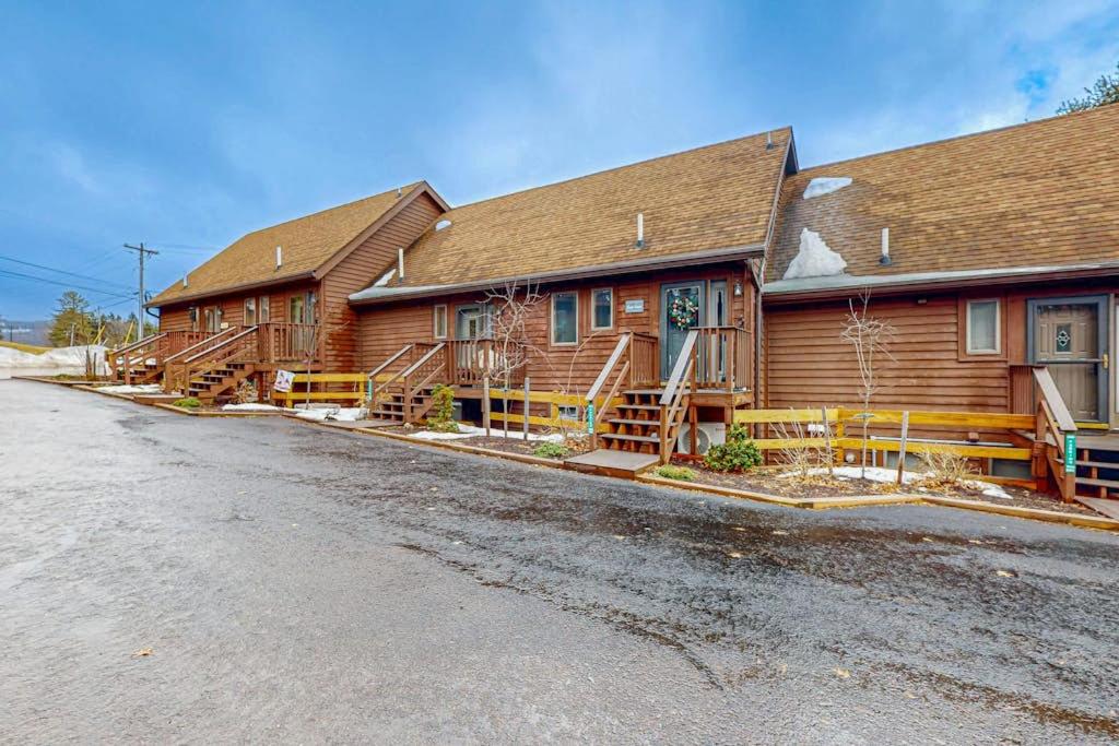 a large log cabin with a road in front of it at Sans Souci in McHenry