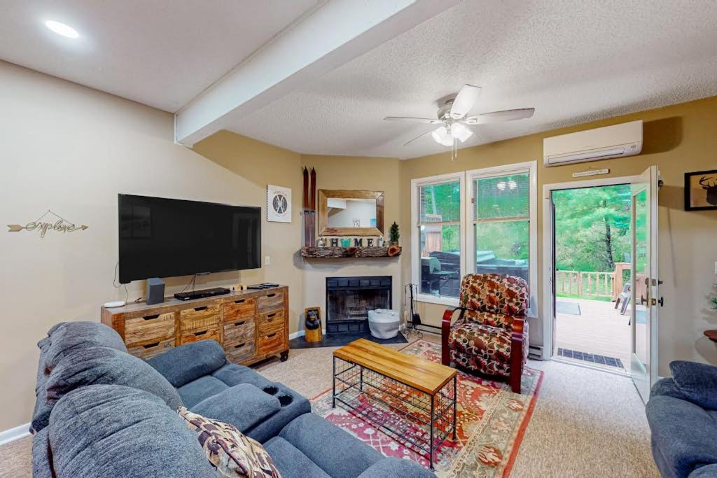 a living room with a blue couch and a flat screen tv at Stella's Retreat in McHenry