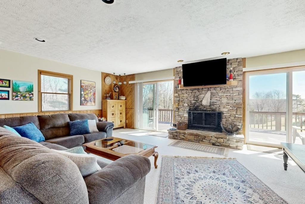 a living room with a couch and a fireplace at Nimba Cabin in Oakland