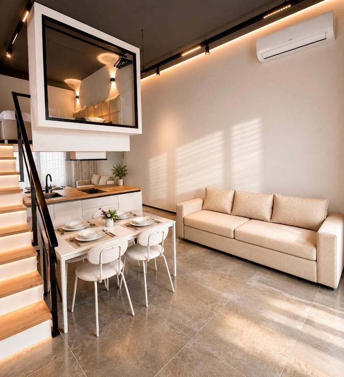 a living room with a table and a couch at ALZETA Aparthotel in Durrës