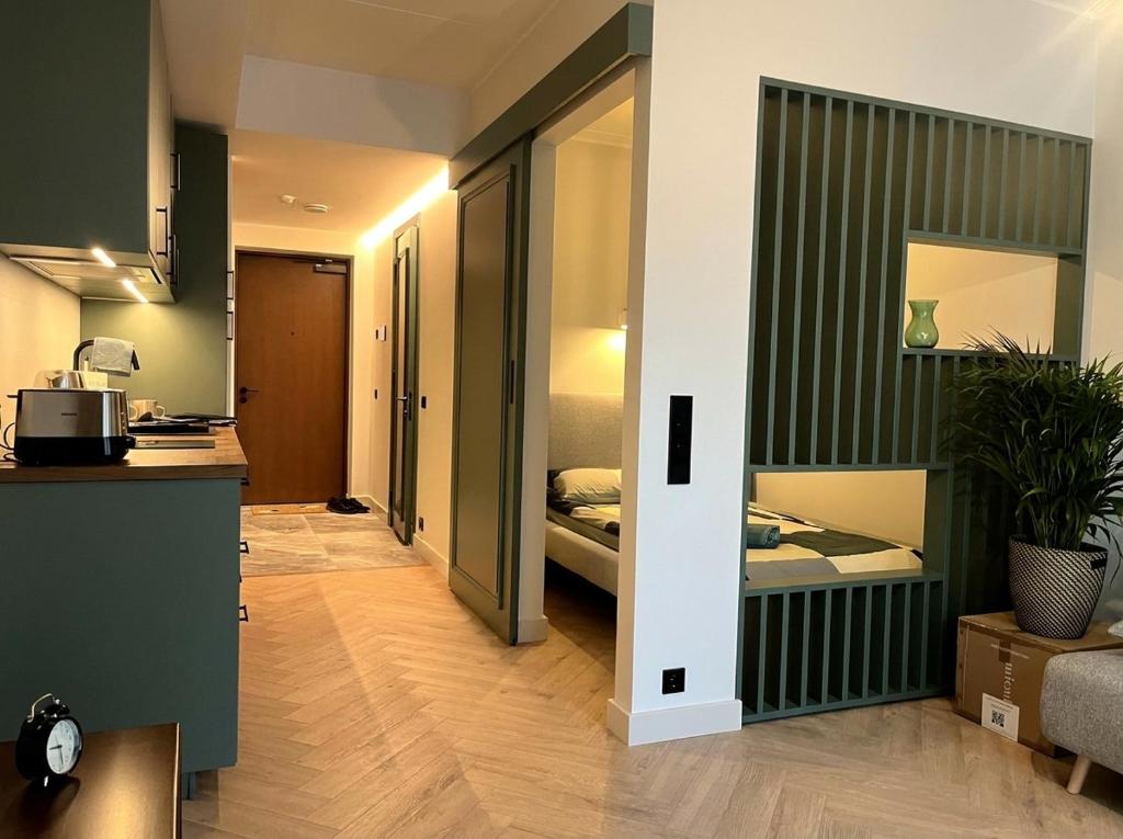 a room with a kitchen and a bedroom with a bed at Oru Park & Sea Apartment in Tallinn