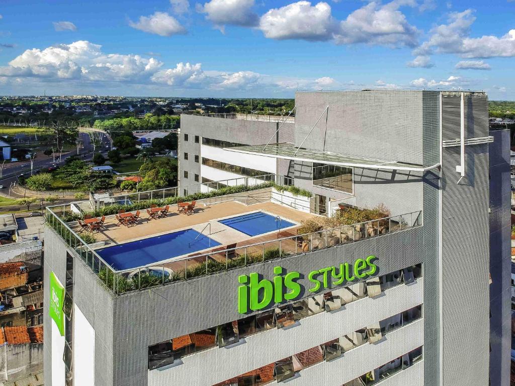 an office building with a big sticks sign on it at Ibis Styles Belém Hangar in Belém