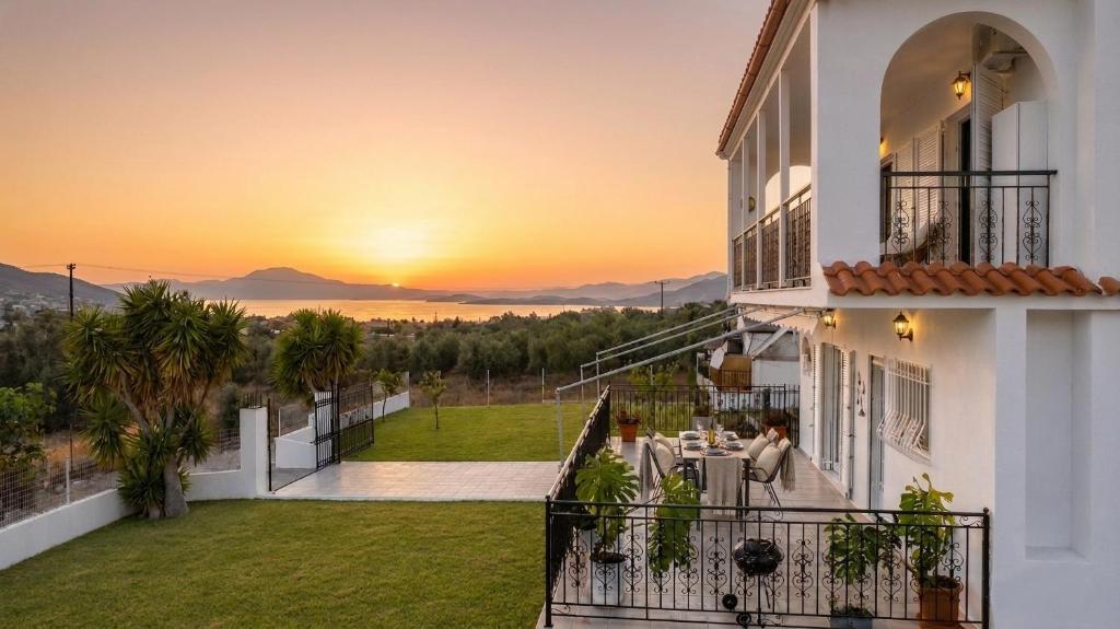 a view of the sunset from the balcony of a house at Villa Aelia Luxury Maisonette in Salamina