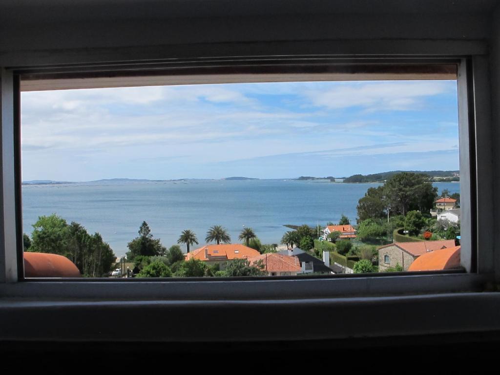 a view of the water from a window at Ático Yuly in Rianjo