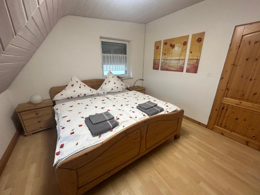 a bedroom with a large bed with red flowers on it at Wohnung an der schönen Aue Stadtzentrumsnähe in Fulda