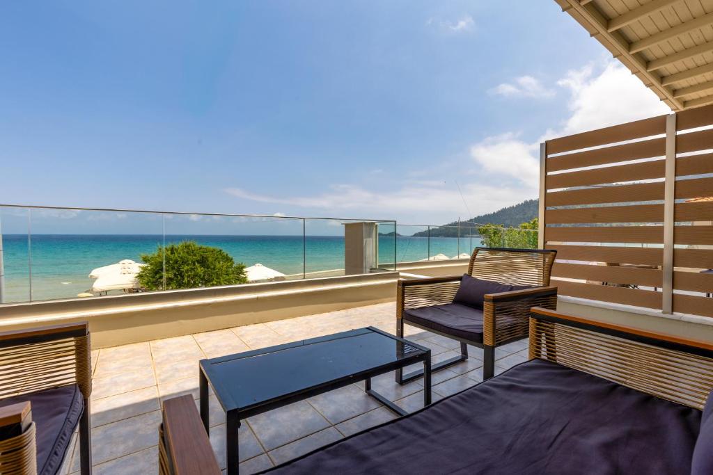 a balcony with two benches and a view of the ocean at Kastalia Studios And APARTMENTS in Skala Potamias