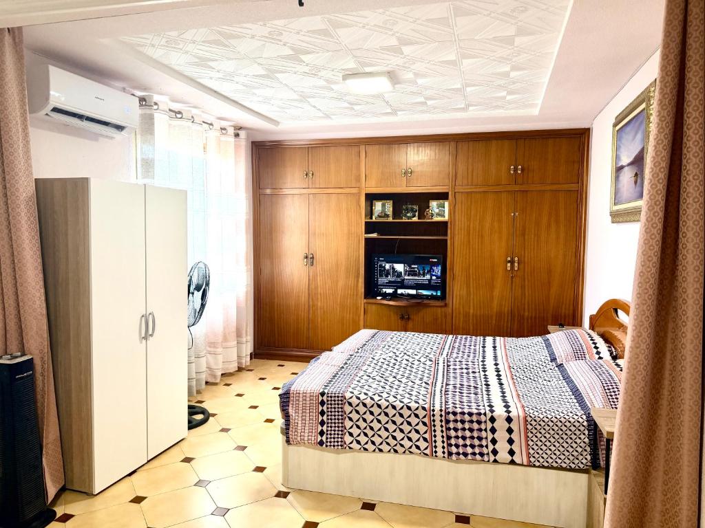 a bedroom with a bed and wooden cabinets at Casa Carlos de Novelda in Novelda