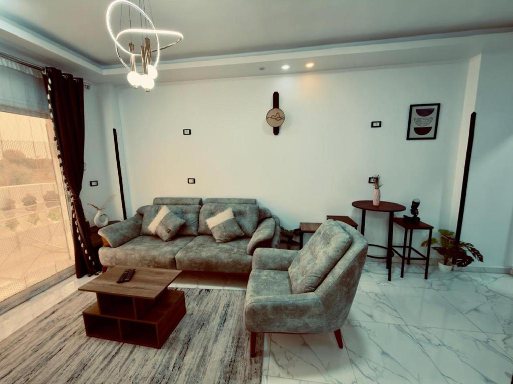 a living room with a couch and a chair at private studio - djorff area in Al Aqālitah