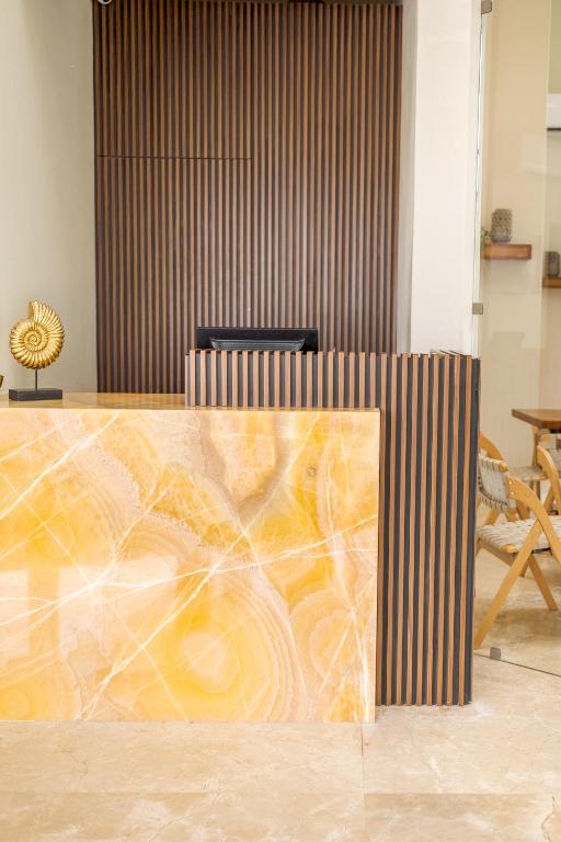 a desk with a painting on it in a room at HOTEL CARASOL VILLAS & SUITES in Ciudad Madero