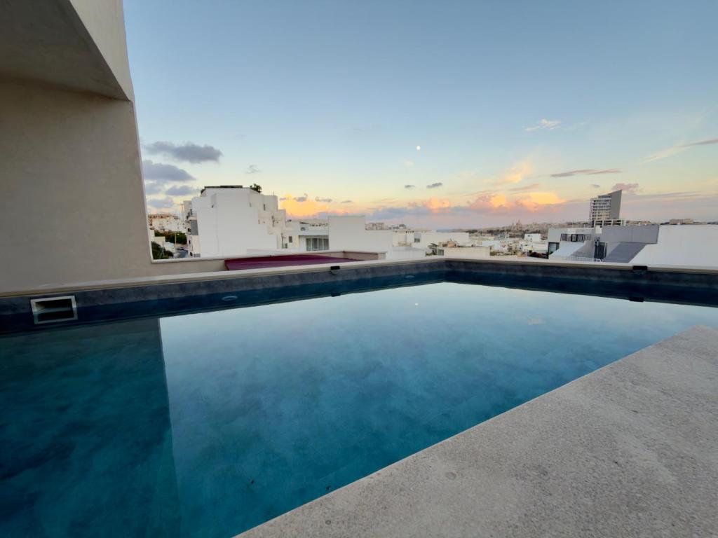 a swimming pool on the roof of a building at Eva's Penthouse with private Swimming pool by ELDI in Il-Gżira