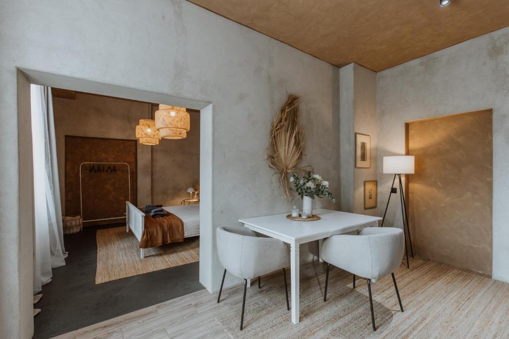 a room with a table and chairs and a bedroom at Buntes nams l Self check-in l Private entrance in Limbaži