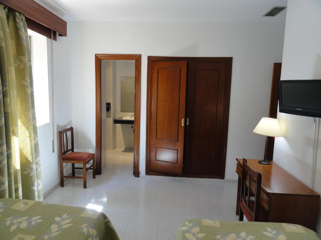 Postel nebo postele na pokoji v ubytování Hotel El Coloso
