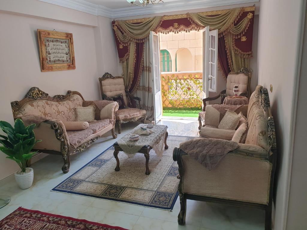 a living room with couches and a table and a window at Apartment Alexandria City Center in Alexandria