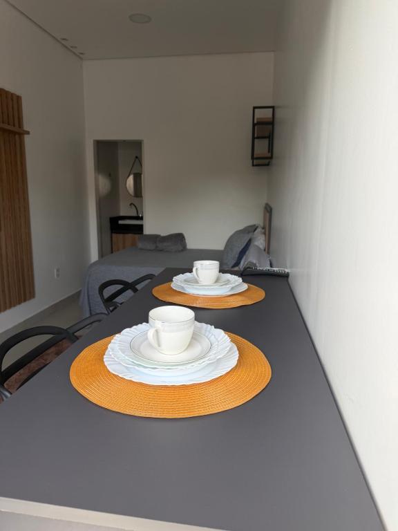 a table with two cups and plates on it at Loft bem localizado na cidade! in Boa Vista