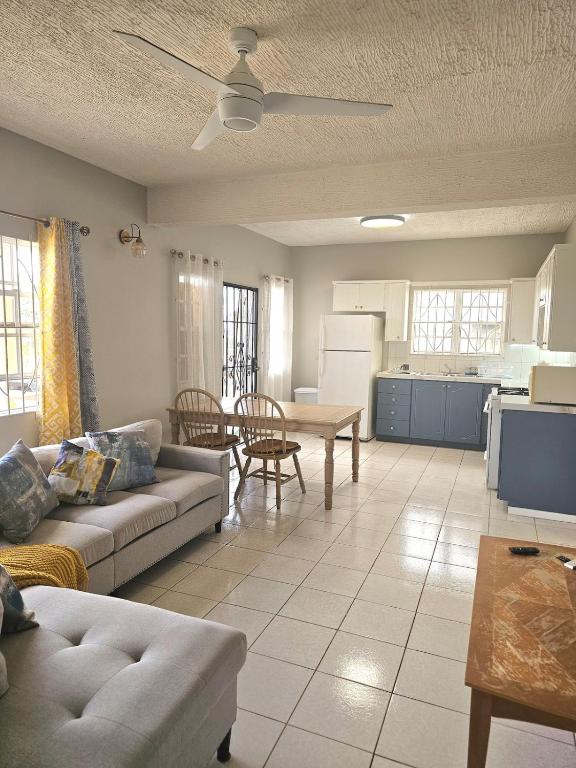 a living room with a couch and a table at Ocean Breeze Retreat in Basseterre