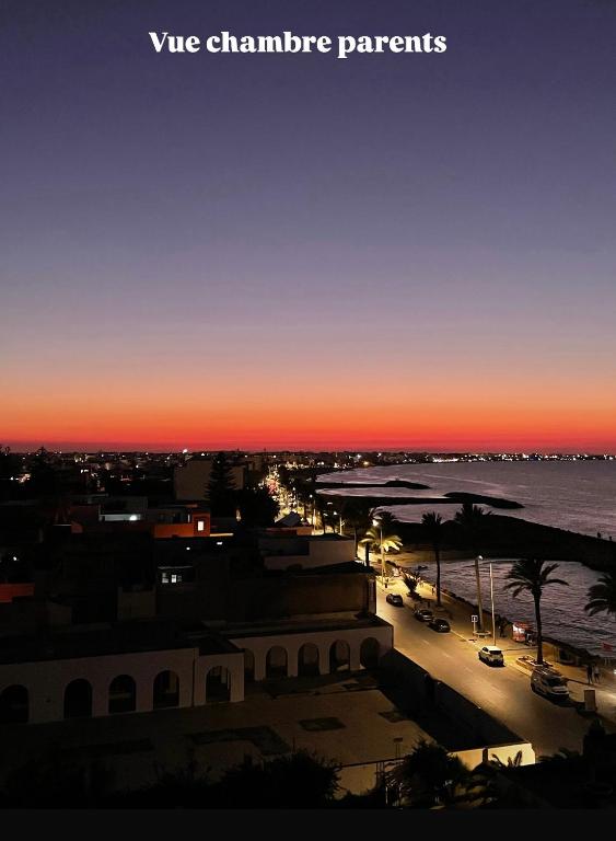 a view of a city with a sunset at Appartement S3 in Mahdia in Mahdia