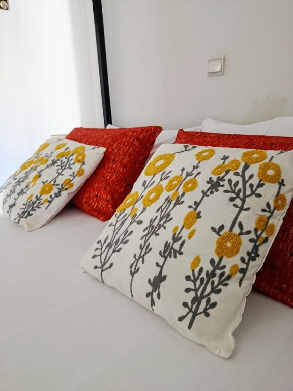 two pillows sitting on top of a bed at Villa DOUDOU in Somone