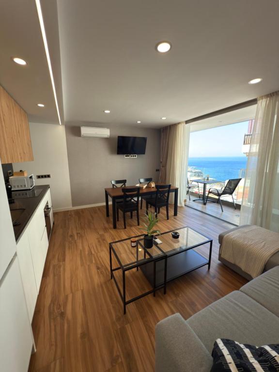 a living room with a couch and a table at Seba Deluxe Home in Puerto de Santiago