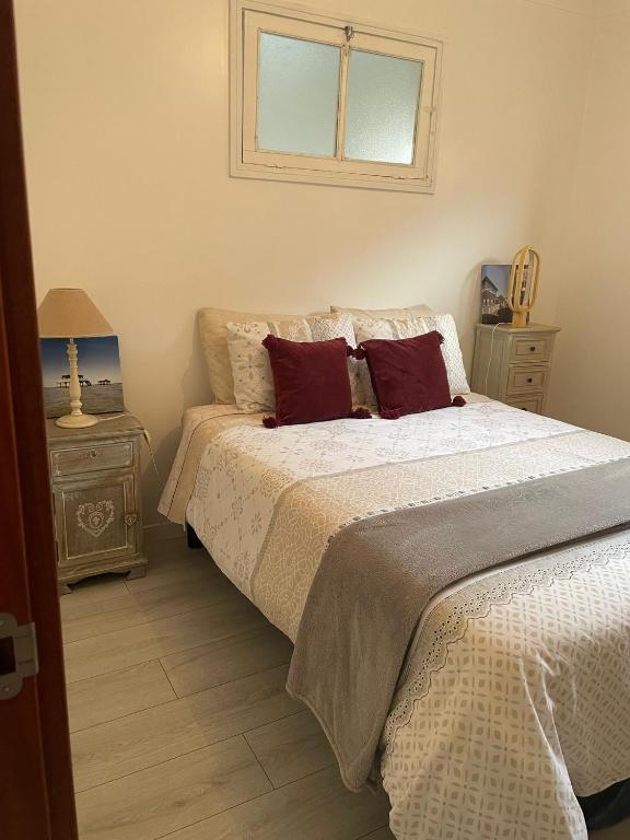 a bedroom with a bed with two pillows and a window at Casa Do Sino II in Arcos de Valdevez