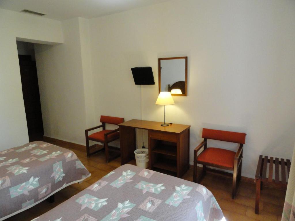Postel nebo postele na pokoji v ubytování Hotel El Coloso
