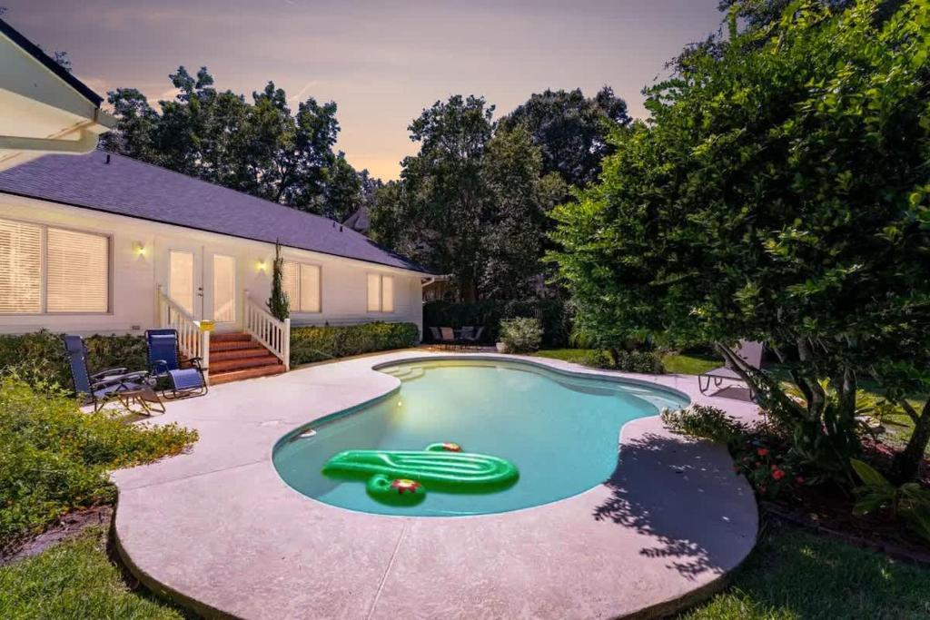 a small swimming pool with a green toy in the yard at Costal Lane - Main in Jacksonville