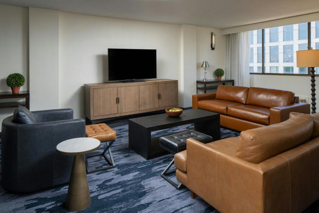 a living room with furniture and a flat screen tv at Fairfield Inn & Suites by Marriott Charlotte Uptown in Charlotte