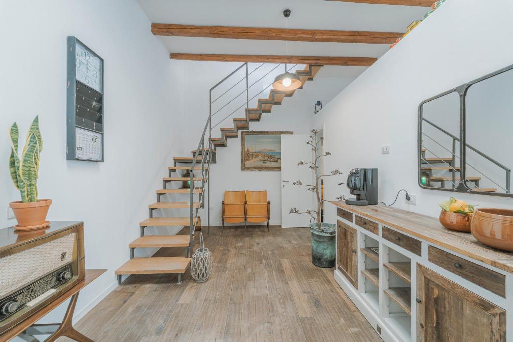 a living room with a staircase in a house at Casa Ritunno Rooms in Favignana