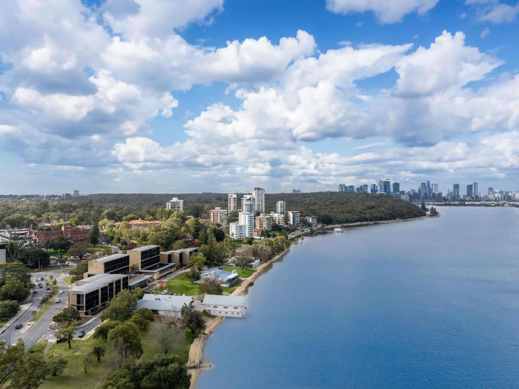a view of a river with a city in the background at Wonil Hotel Perth - Handwritten Collection in Perth