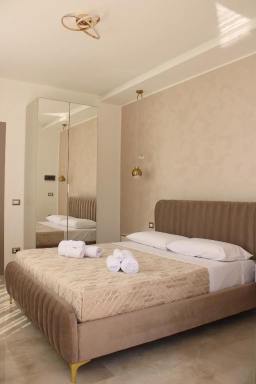 a bedroom with two beds with towels on them at Aurea Rooms in Porto Cesareo