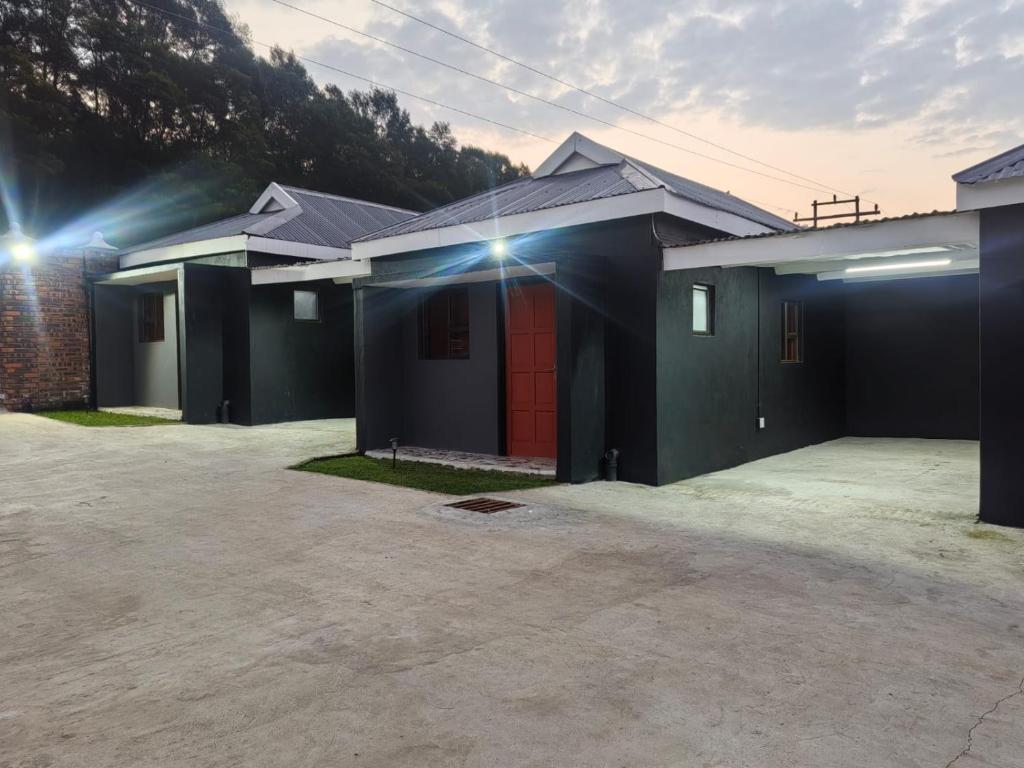a row of houses with a parking lot at Qten Camp in Pietermaritzburg