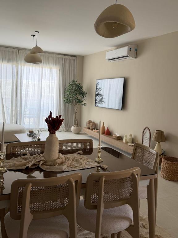 a living room with a dining room table and chairs at D bay north coast chalet in El Dab‘a