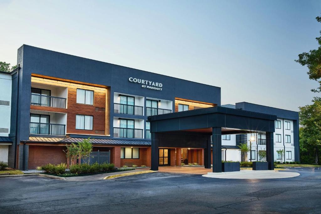 a building with a parking lot in front of it at Courtyard Memphis Germantown in Memphis