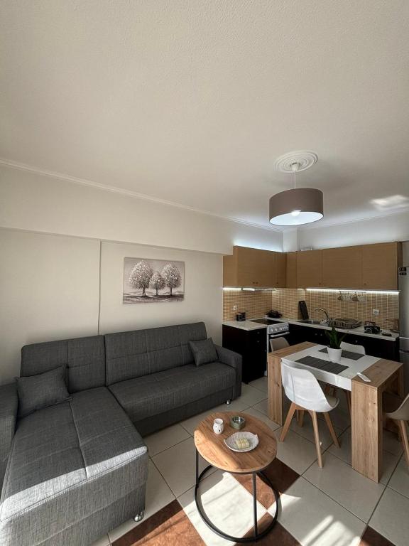 a living room with a couch and a table at My Chios Apartments in Chios