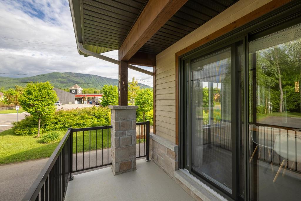a balcony with a view of the mountains at EdenCat Condo - Mountain View in Beaupré